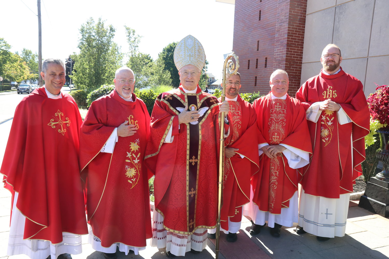 Pictured from left, Father David Procaccini, Father Bernard Healey, Bishop Evans, Father Carl Fisette, Father David Gaffney and Father Daniel Mahoney at OLM Friday.